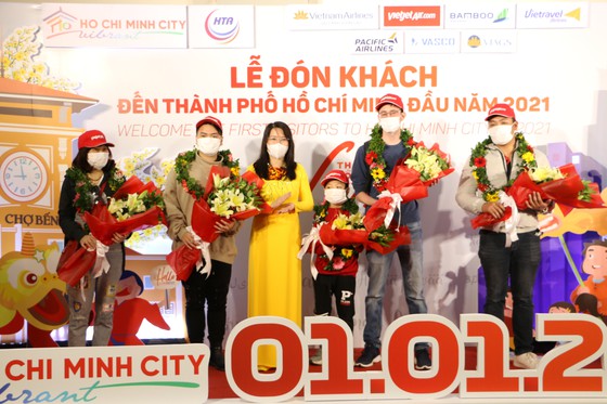Giám đốc  Sở Du lịch TPHCM Nguyễn Thị Ánh Hoa tặng hoa chúc mừng những vị khách đầu tiên