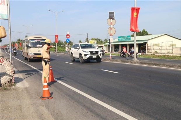 Tổ cảnh sát giao thông làm nhiệm vụ trên Quốc lộ 1 thuộc huyện Châu Thành, Tiền Giang. (Ảnh: Minh Trí/TTXVN)