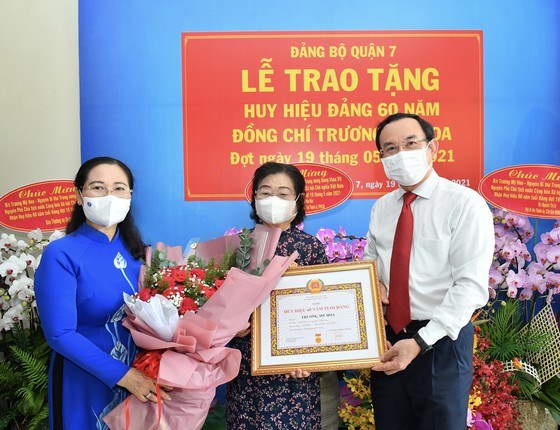 B&iacute; thư Th&agrave;nh ủy TPHCM Nguyễn Văn N&ecirc;n v&agrave; Chủ tịch HĐND TPHCM Nguyễn Thị Lệ trao Huy hiệu 60 năm tuổi Đảng v&agrave; tặng hoa ch&uacute;c mừng đồng ch&iacute; Trương Mỹ Hoa, s&aacute;ng 19-5-2021. Ảnh: VIỆT DŨNG&nbsp;