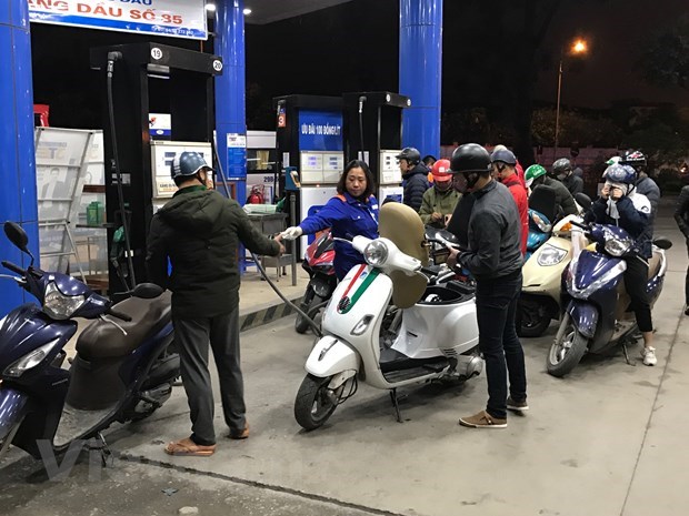 Nh&acirc;n vi&ecirc;n Petrolimex đang b&aacute;n xăng cho kh&aacute;ch h&agrave;ng. (Ảnh: Đức Duy/Vietnam+)