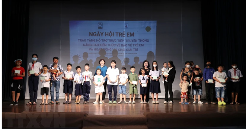 Đại diện Hội Bảo trợ Trẻ em Thành phố Hồ Chí Minh trao tặng kinh phí hỗ trợ chăm sóc sức khỏe cho trẻ có hoàn cảnh đặc biệt khó khăn, mắc bệnh hiểm nghèo. (Ảnh: Thanh Vũ/TTXVN)