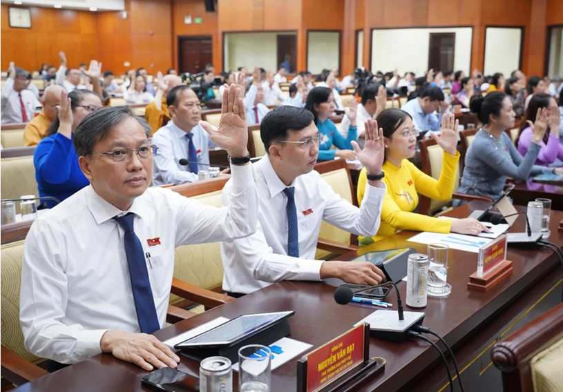 Đại biểu biểu quyết th&ocirc;ng qua nghị quyết. Ảnh: THUẬN VĂN